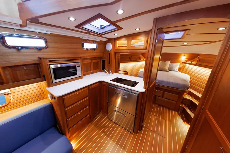 Slide: The Image of Luxurious interior of 2022 Sabre 38 SE yacht with modern kitchen and cozy bedroom. - 14