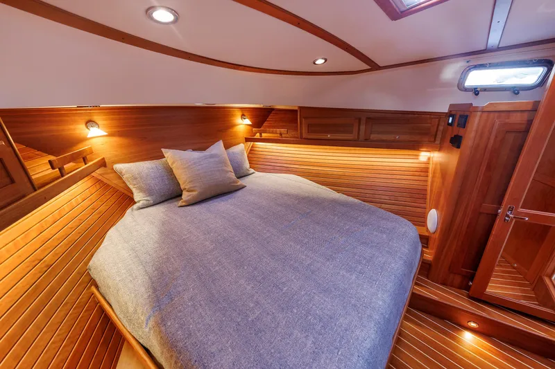 Slide: The Image of Luxurious cabin interior of 2022 Sabre 38 SE yacht with cozy bedding and warm lighting. - 20