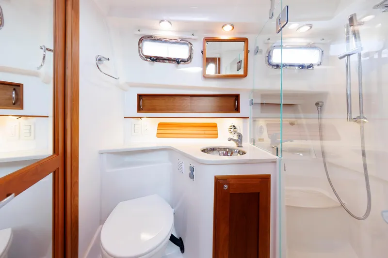 Slide: The Image of 2022 Sabre 38 SE yacht bathroom with modern fixtures and wooden accents. - 25