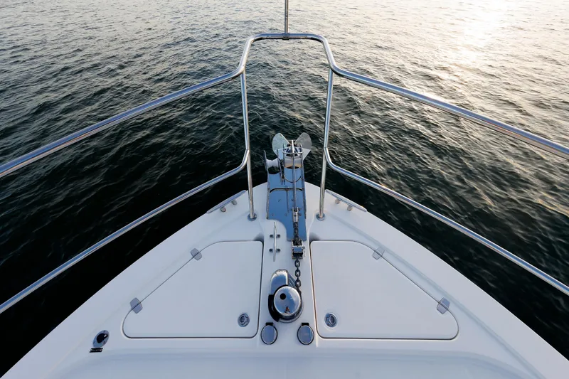 Slide: The Image of Bow of 2022 Sabre 38 SE yacht on calm water at sunset. - 27