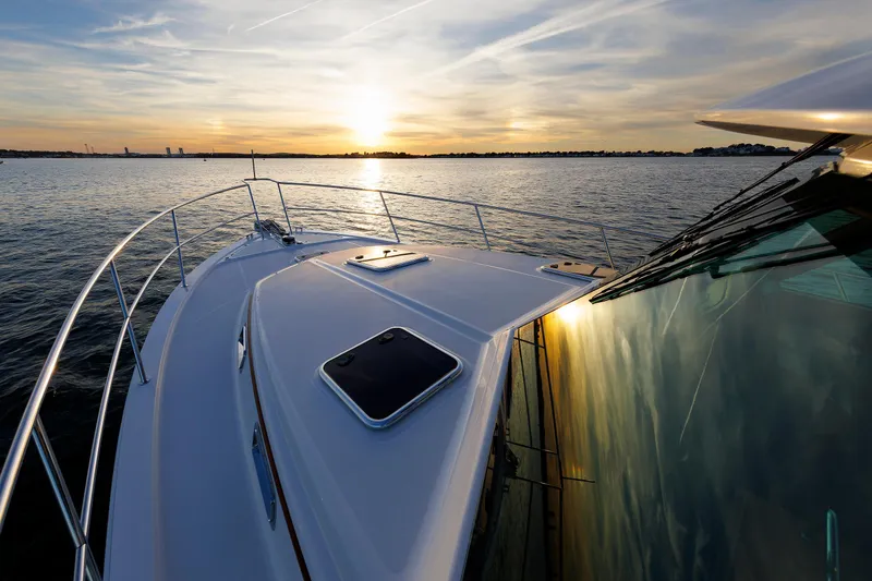 Slide: The Image of 2022 Sabre 38 SE yacht cruising at sunset on calm waters. - 28