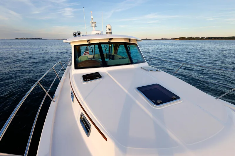 Slide: The Image of 2022 Sabre 38 SE yacht cruising on calm waters at sunset. - 29