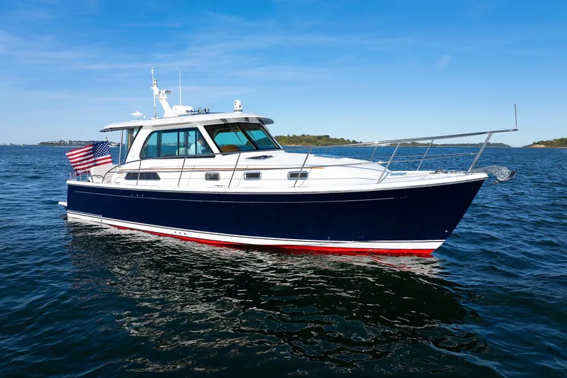 Slide: The Image of 2022 Sabre 38 SE yacht on open water, featuring sleek design and American flag. - 4