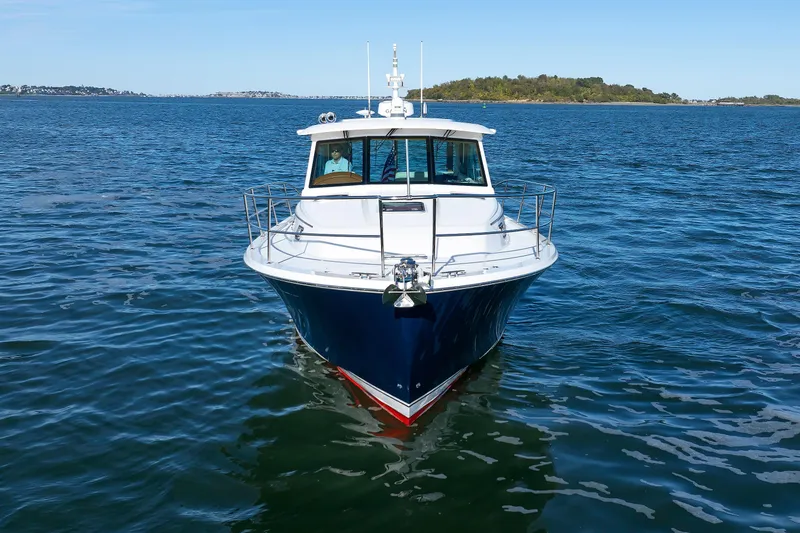 Slide: The Image of 2022 Sabre 38 SE yacht on open water, front view with clear blue sky. - 5