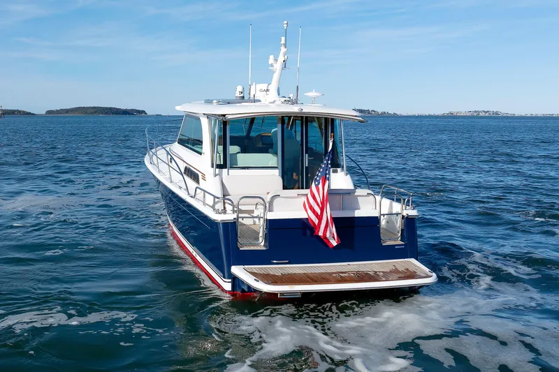 Slide: The Image of 2022 Sabre 38 SE yacht cruising on open water with American flag. - 6