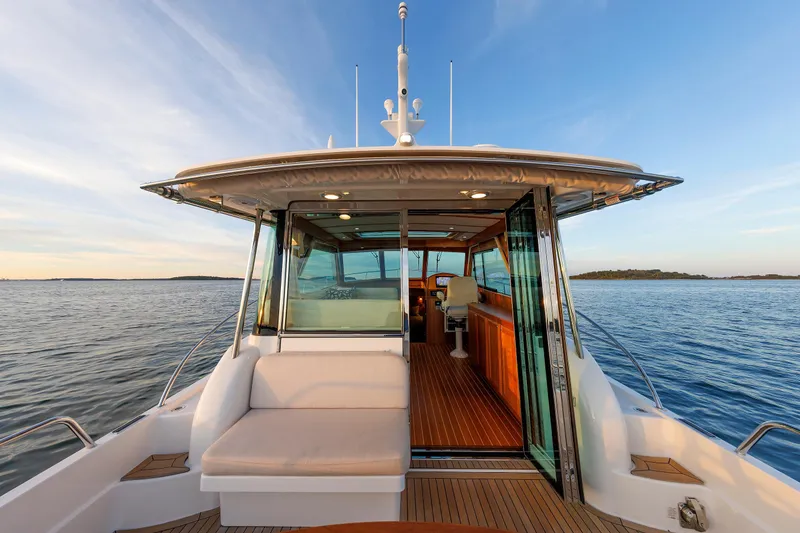 Slide: The Image of 2022 Sabre 38 SE yacht with open cabin, cruising on calm waters at sunset. - 9