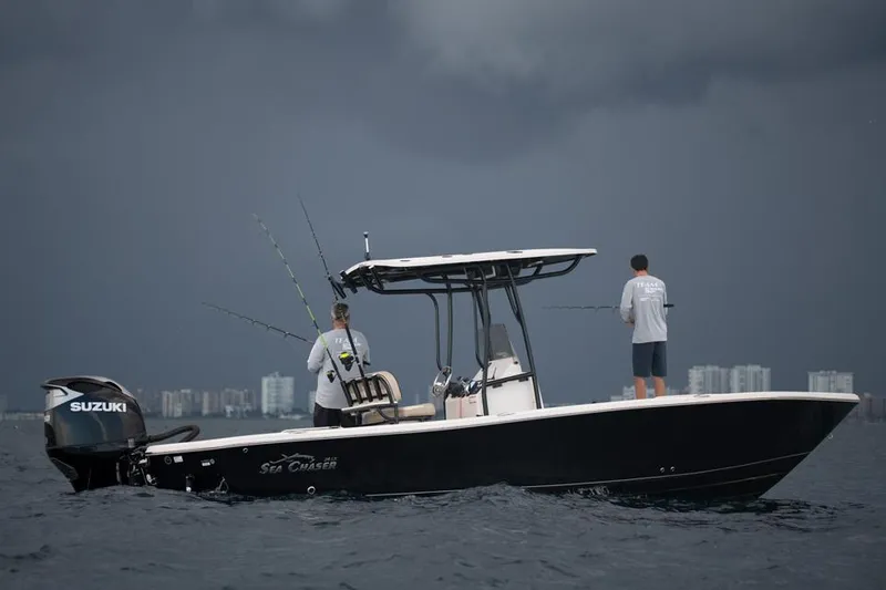 Slide: The Image of 2026 Sea Chaser 26 LX boat displayed indoors at a marine exhibition. - 2