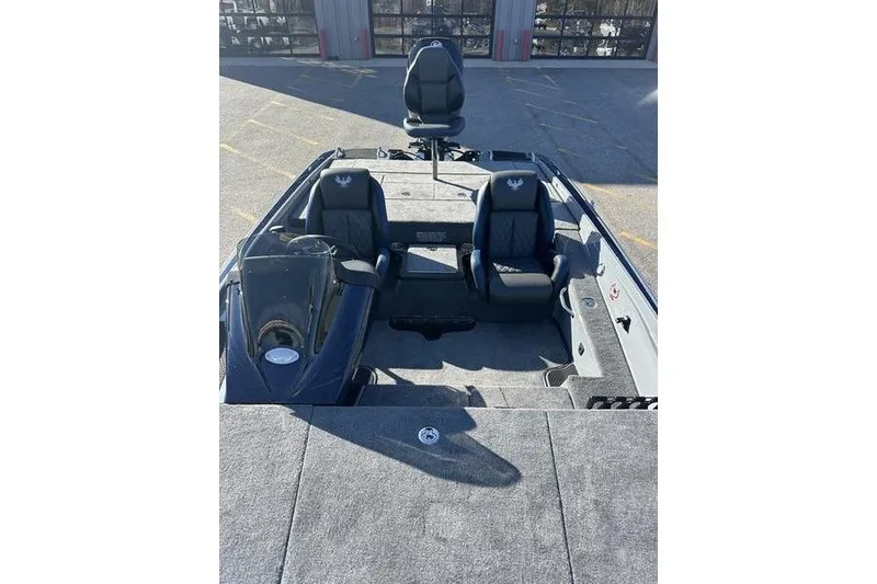 Slide: The Image of 2026 Phoenix 721 ZXL boat interior with seating and console, parked outdoors. - 11