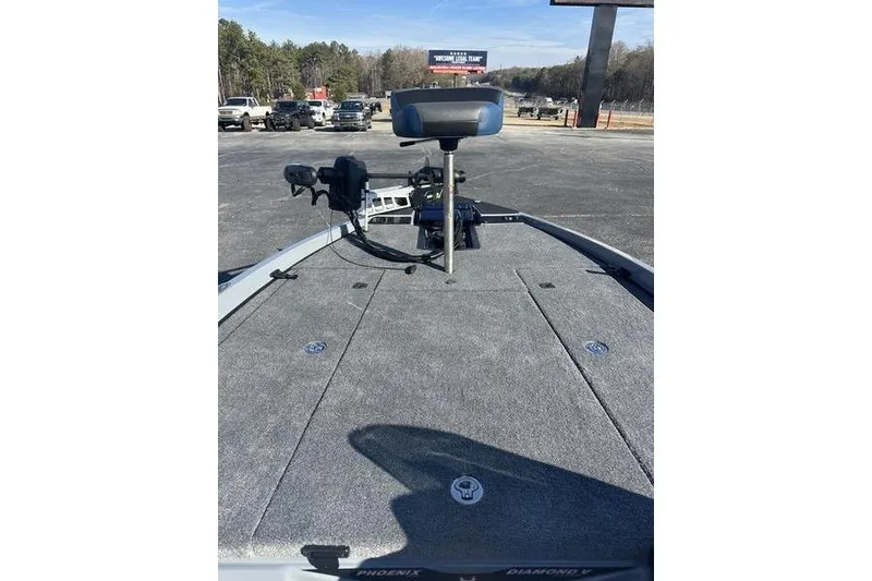 Slide: The Image of 2026 Phoenix 721 ZXL boat deck with seat and equipment, parked outdoors. - 15