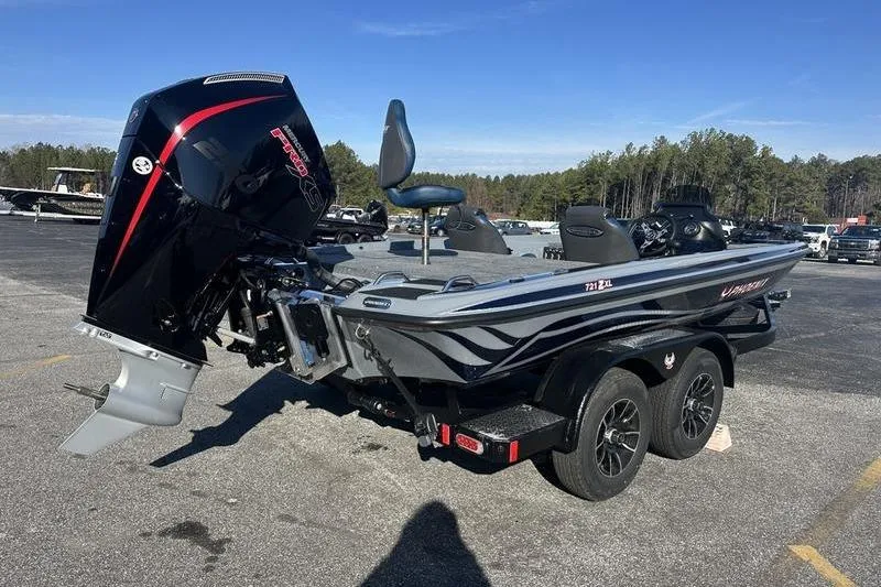 Slide: The Image of 2026 Phoenix 721 ZXL boat with powerful outboard motor in a parking lot. - 6