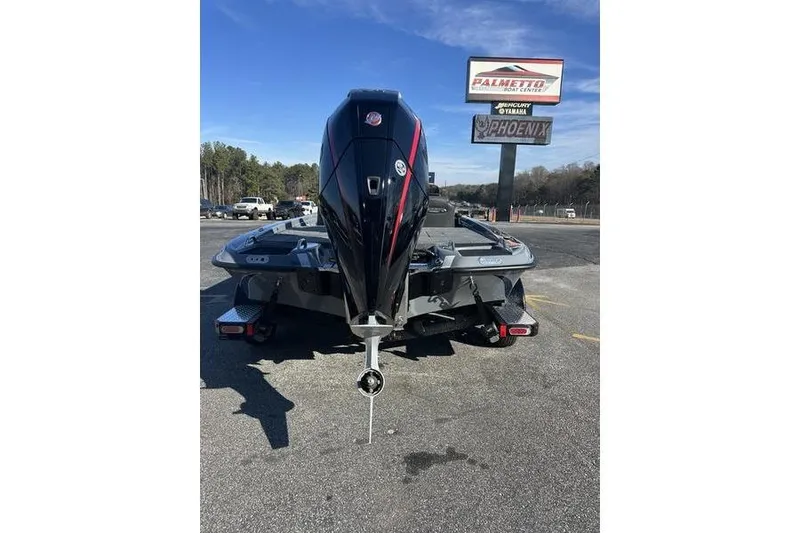 Slide: The Image of 2026 Phoenix 721 ZXL boat with powerful outboard motor, parked at dealership. - 7