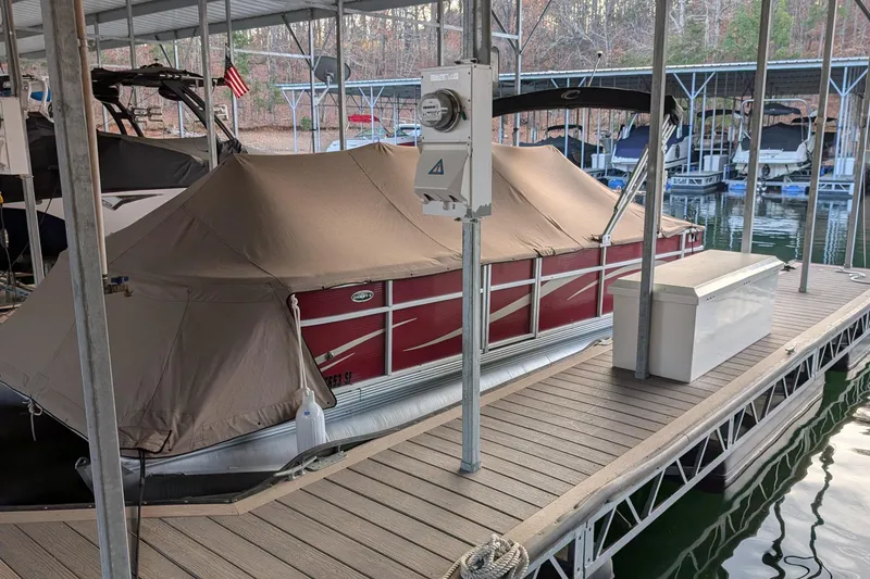 Slide: The Image of Covered 2012 Crest CHILLER CP2 boat docked at marina with utility box nearby. - 17