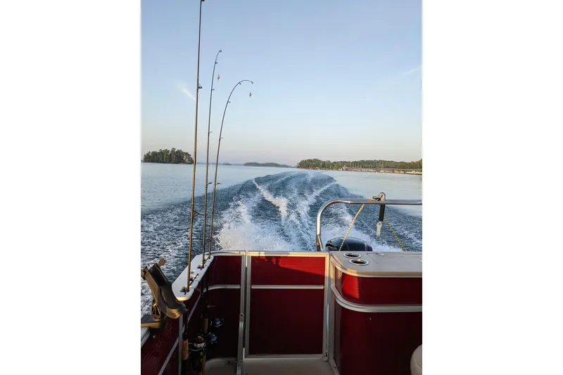 Slide: The Image of Pontoon boat on lake with fishing rods, creating wake, clear sky, Crest CHILLER CP2, 2012. - 7