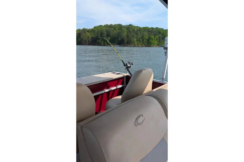 Slide: The Image of Pontoon boat interior with fishing rod, Crest CHILLER CP2, 2012 model, on a scenic lake. - 9