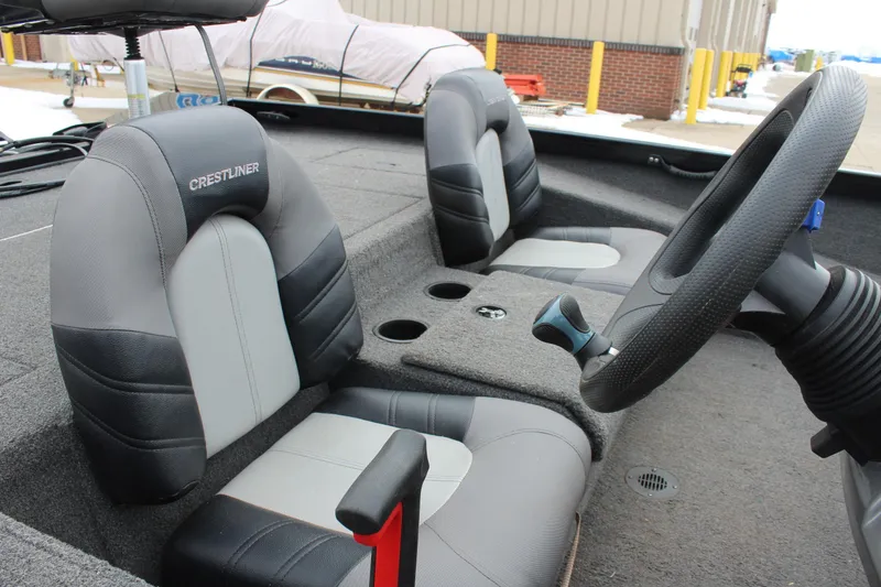 Slide: The Image of 2019 Crestliner VT 18 boat interior with steering wheel and cushioned seats. - 10