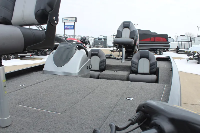 Slide: The Image of 2019 Crestliner VT 18 boat interior with seating and control console, displayed outdoors. - 15