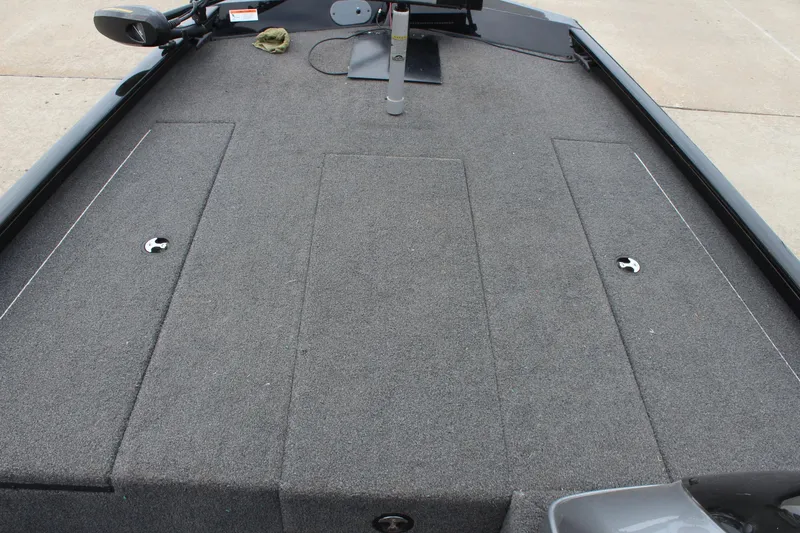 Slide: The Image of 2019 Crestliner VT 18 boat deck with gray carpet and storage compartments. - 18