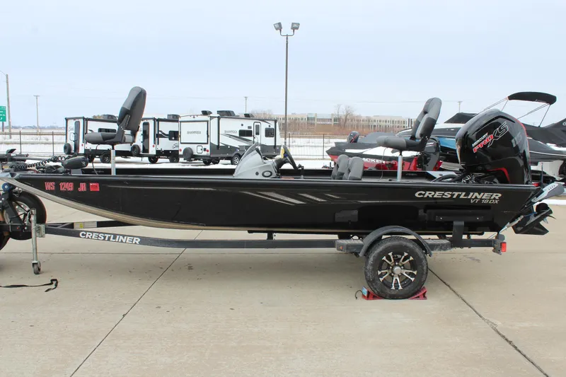 Slide: The Image of 2019 Crestliner VT 18 boat on trailer, parked outdoors, side view. - 4