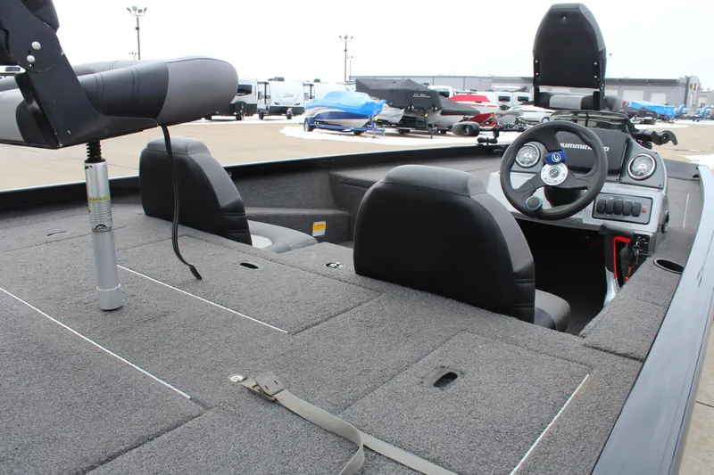 Slide: The Image of 2019 Crestliner VT 18 boat interior with steering wheel and seating, parked outdoors. - 8