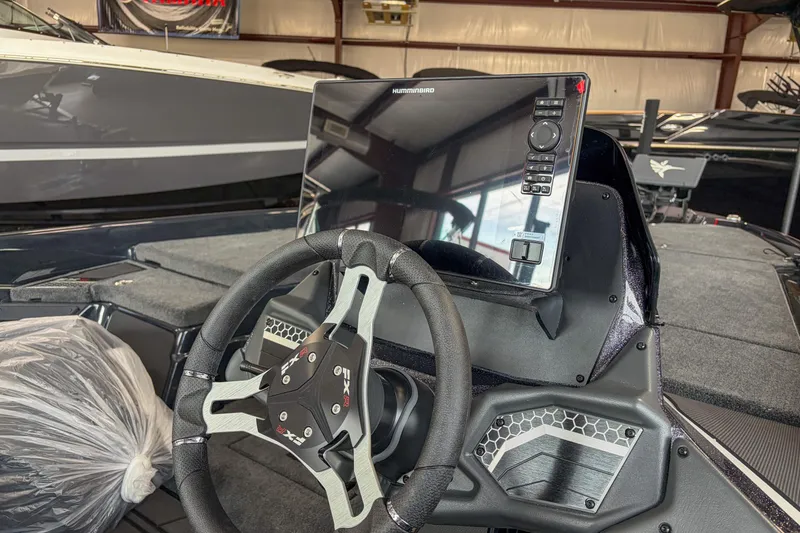 Slide: The Image of 2026 Skeeter FXR20 FLEX boat dashboard with steering wheel and electronic display. - 10