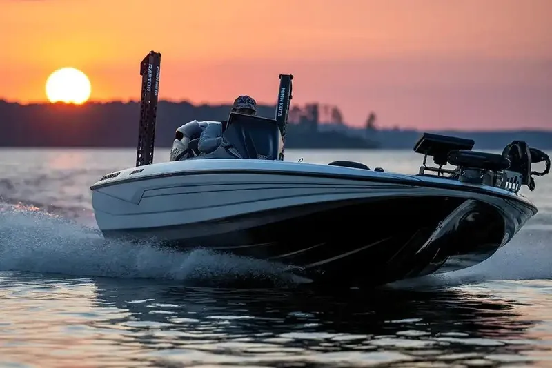 Slide: The Image of Manufacturer Provided Image: 2026 Skeeter FXR20 FLEX boat cruising at sunset on a serene lake. - 11