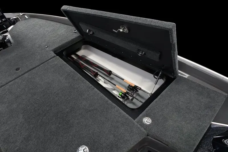 Slide: The Image of Manufacturer Provided Image: 2026 Skeeter FXR20 FLEX boat with open storage compartment holding fishing rods. - 12