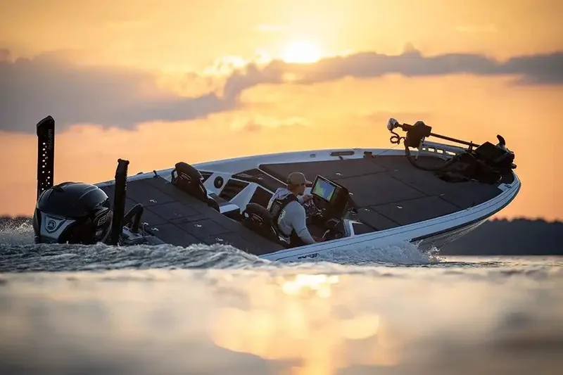 Slide: The Image of Manufacturer Provided Image: 2026 Skeeter FXR20 FLEX boat cruising at sunset on a serene lake. - 14