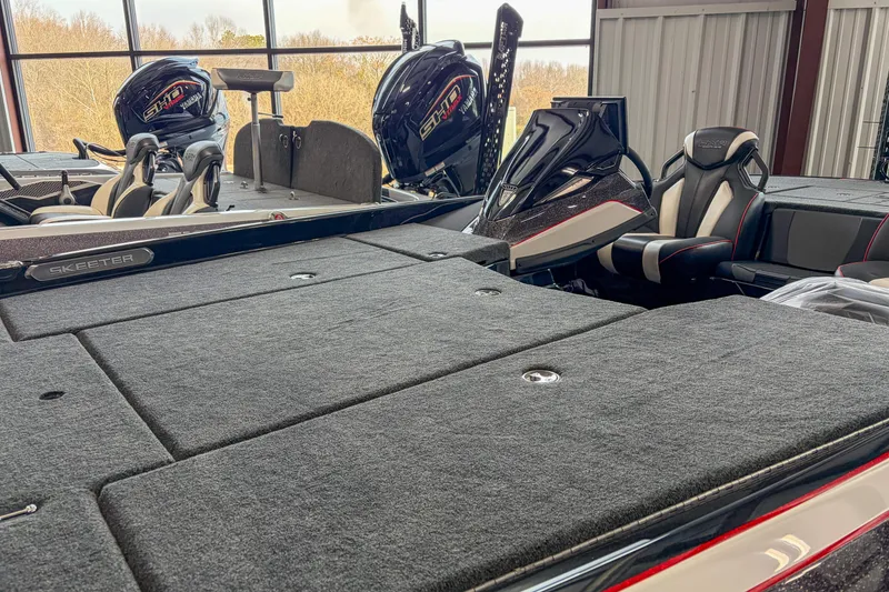 Slide: The Image of 2026 Skeeter FXR20 FLEX boat interior with dual engines in a showroom. - 4