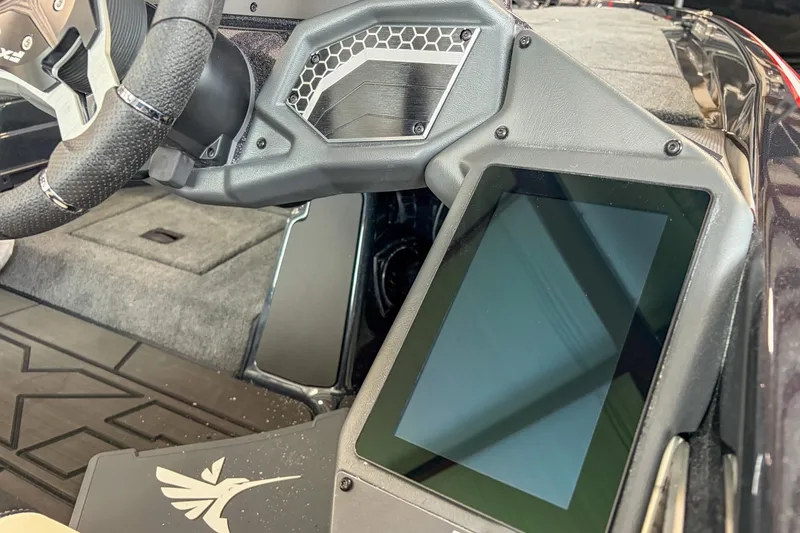 Slide: The Image of 2026 Skeeter FXR20 FLEX boat dashboard with touchscreen display and steering wheel. - 9