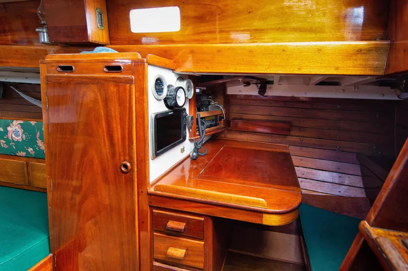 Slide: The Image of 1957 Sparkman & Stephens K/CB Yawl interior with wooden navigation station and vintage instruments. - 10