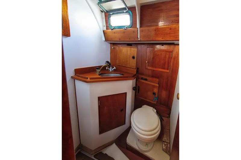 Slide: The Image of 1957 Sparkman & Stephens K/CB Yawl bathroom with wooden cabinetry and compact design. - 14
