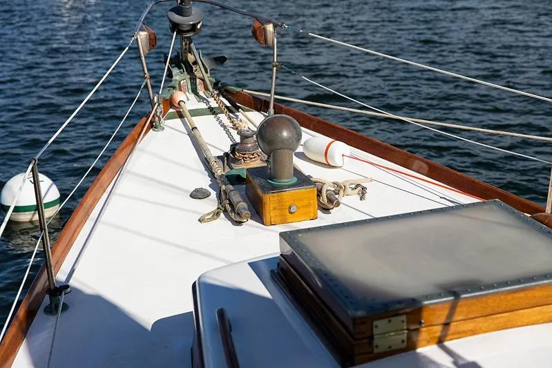 Slide: The Image of 1957 Sparkman & Stephens K/CB Yawl deck with ropes and wooden details on water. - 15