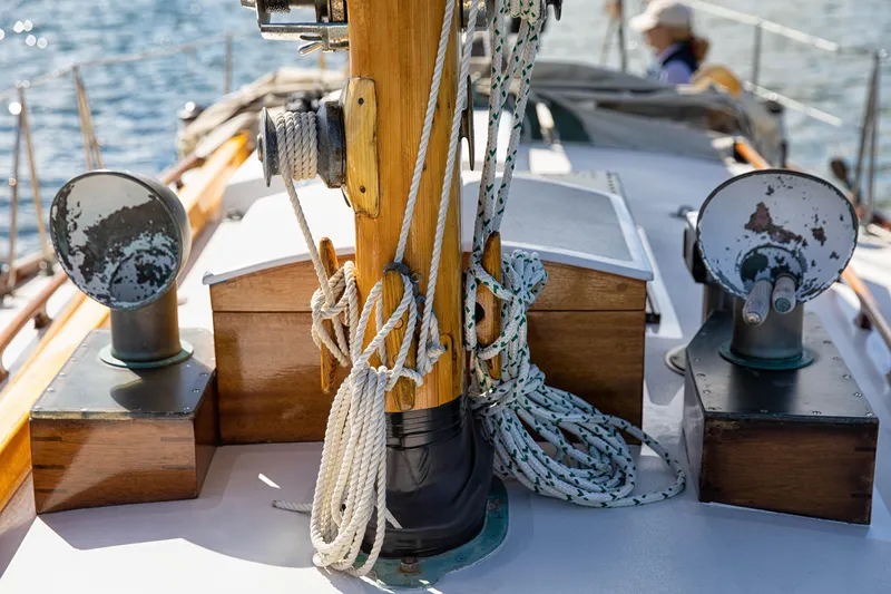 Slide: The Image of 1957 Sparkman & Stephens K/CB Yawl deck with ropes and wooden details. - 19