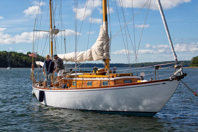 Slide: The Image of 1957 Sparkman & Stephens K/CB Yawl sailing on a sunny day with two people aboard. - 26