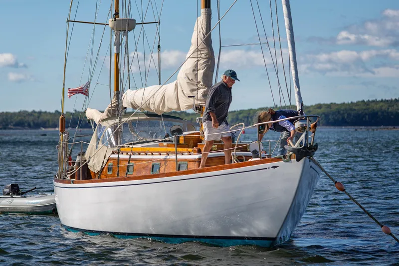 Slide: The Image of 1957 Sparkman & Stephens K/CB Yawl sailing on calm waters with crew onboard. - 28