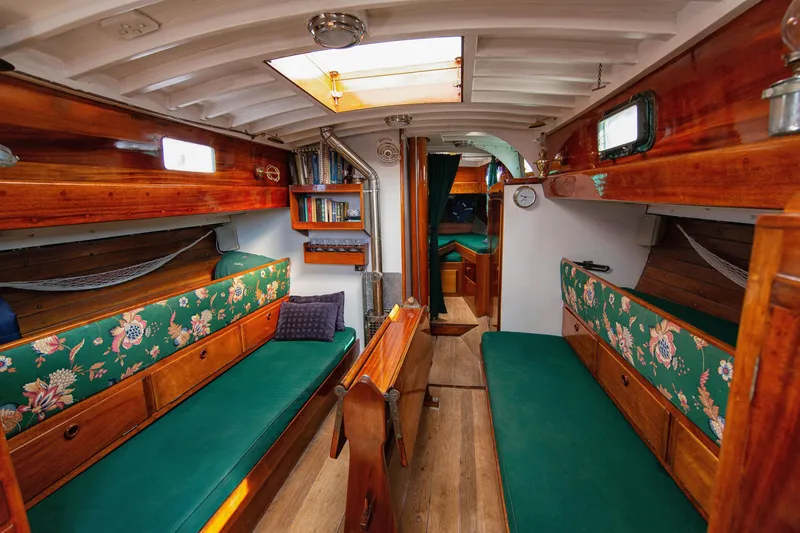 Slide: The Image of Interior of 1957 Sparkman & Stephens K/CB Yawl with wooden furnishings and floral upholstery. - 3