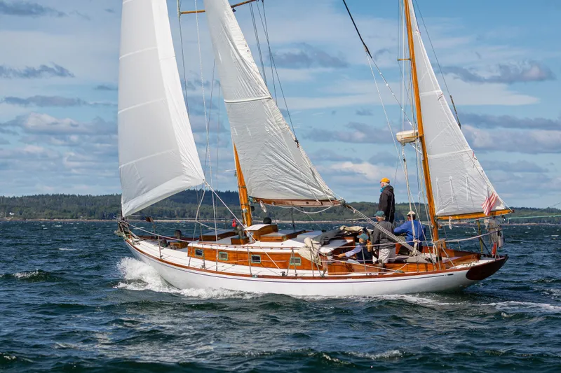 Slide: The Image of 1957 Sparkman & Stephens K/CB Yawl sailing on open water under clear skies. - 35