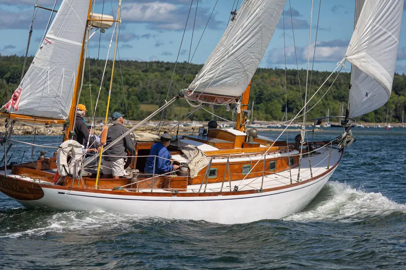 Slide: The Image of 1957 Sparkman & Stephens K/CB Yawl sailing on a scenic waterway. - 36