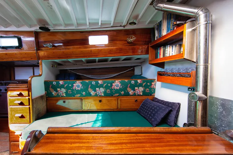 Slide: The Image of Cozy 1957 Sparkman & Stephens K/CB Yawl interior with floral upholstery and wooden accents. - 9