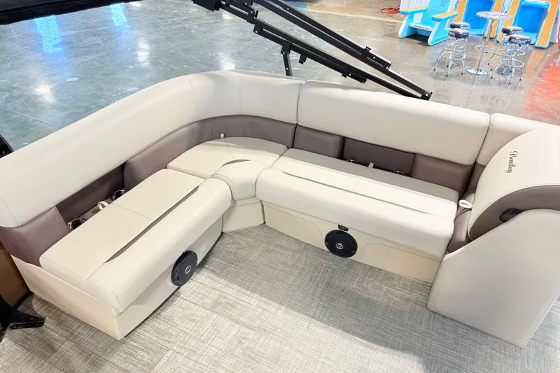Slide: The Image of 2026 Bentley Pontoons LE 180CR interior seating with beige upholstery and integrated speakers. - 7