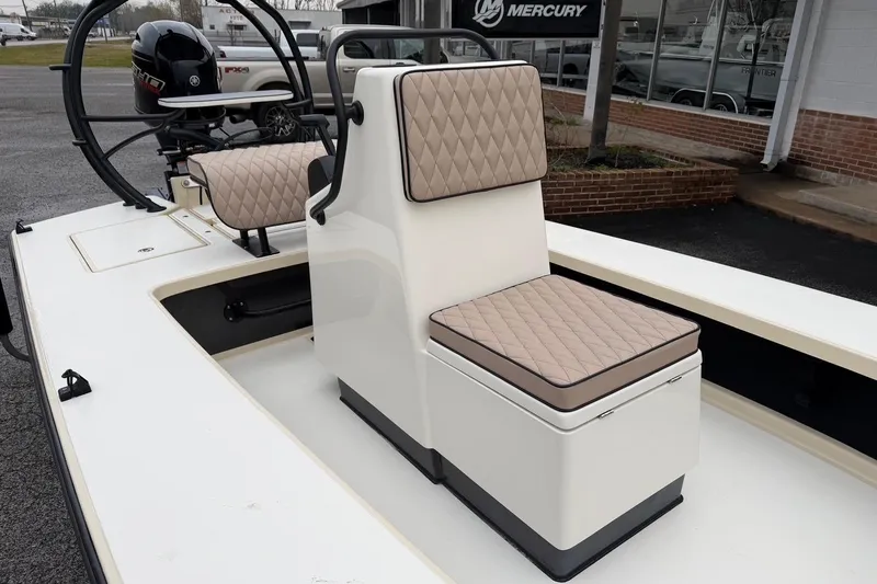 Slide: The Image of 2026 Chittum Skiffs 21 Laguna Madre boat interior with cushioned seating and Mercury engine. - 11