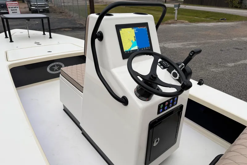 Slide: The Image of 2026 Chittum Skiffs 21 Laguna Madre boat console with navigation display and steering wheel. - 15