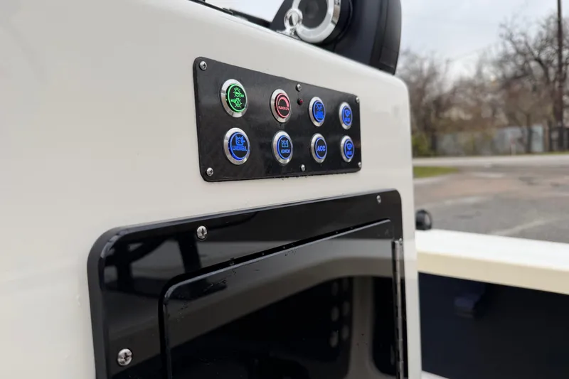 Slide: The Image of Control panel of 2026 Chittum Skiffs 21 Laguna Madre boat with labeled buttons. - 16