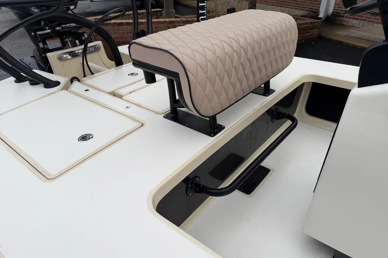 Slide: The Image of 2026 Chittum Skiffs 21 Laguna Madre boat interior with cushioned seat and storage compartments. - 18