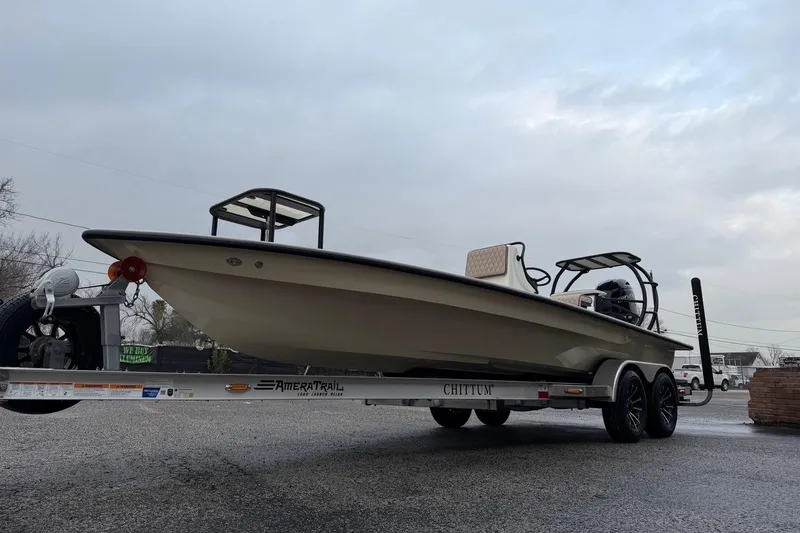 Slide: The Image of 2026 Chittum Skiffs 21 Laguna Madre boat on trailer, overcast sky background. - 4