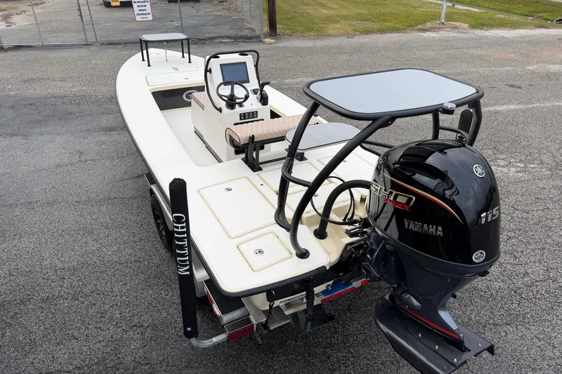Slide: The Image of 2026 Chittum Skiffs 21 Laguna Madre boat with Yamaha engine, parked on a trailer. - 5