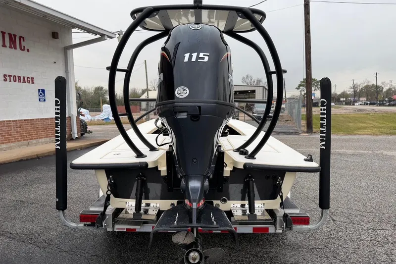 Slide: The Image of 2026 Chittum Skiffs 21 Laguna Madre boat with powerful outboard motor, parked outdoors. - 7