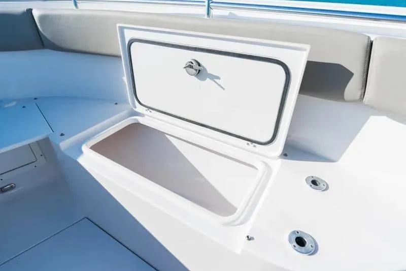 Slide: The Image of 2026 Sportsman Open 282 Center Console boat storage compartment open. - 11