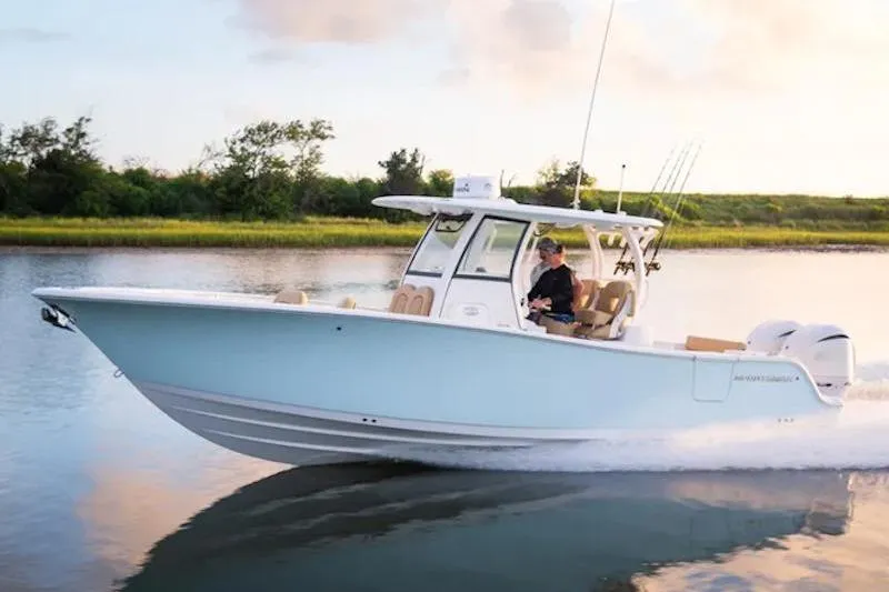 Slide: The Image of 2026 Sportsman Open 282 Center Console boat cruising on a calm waterway. - 14