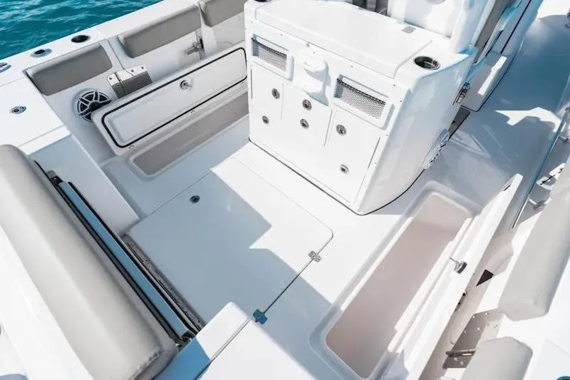 Slide: The Image of 2026 Sportsman Open 282 Center Console boat interior with storage compartments and seating. - 23